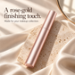Closed rose-gold mascara styled on a pale stone tray and ivory fabric