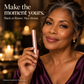 Confident mature woman holding rose-gold mascara in an evening beauty portrait